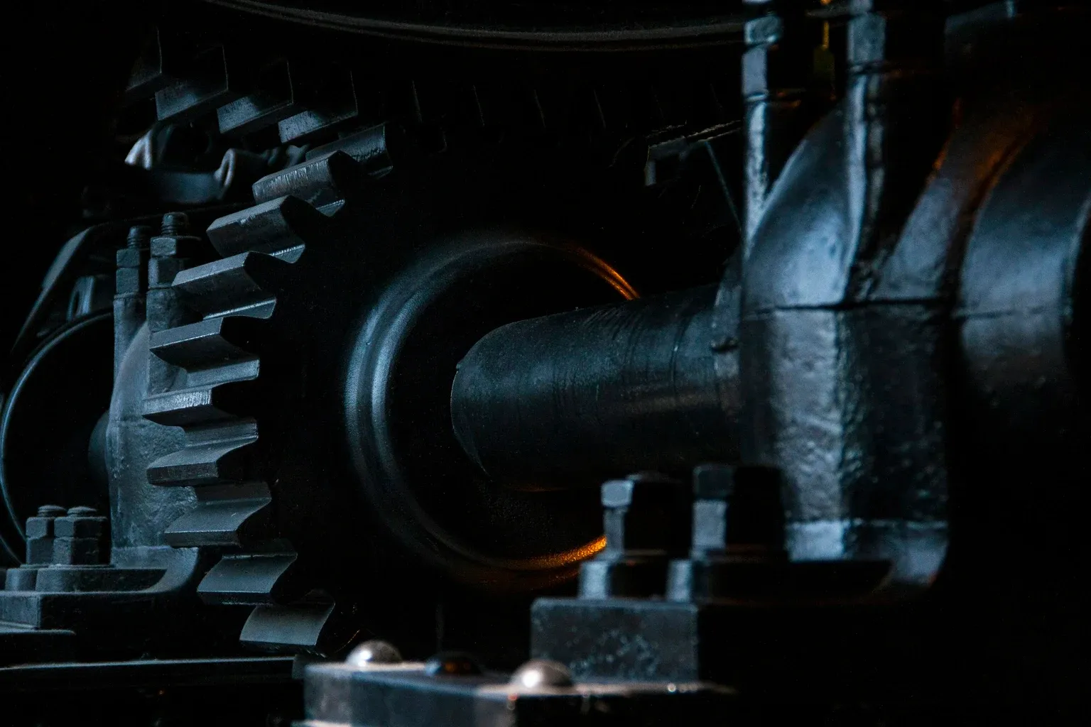 Large metal gears and a shaft in an industrial mechanism