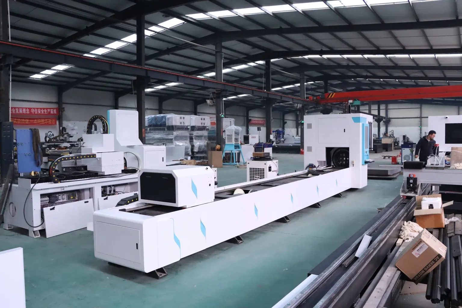 Industrial workshop with CNC machines and an overhead gantry crane