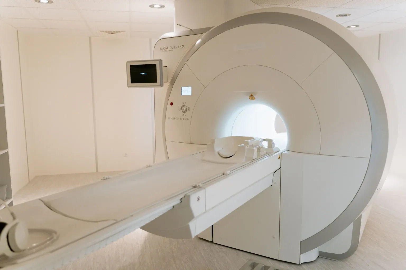 MRI scanner with an extended patient table in a diagnostic room